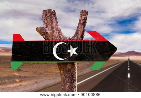 Libya Flag wooden sign with desert road background