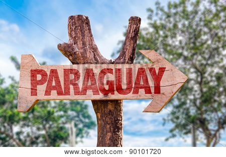 Paraguay wooden sign with countryside background