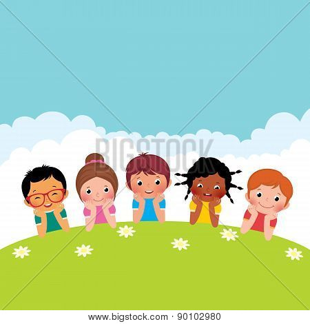 Group Of Happy Children Boys And Girls Lying On The Grass