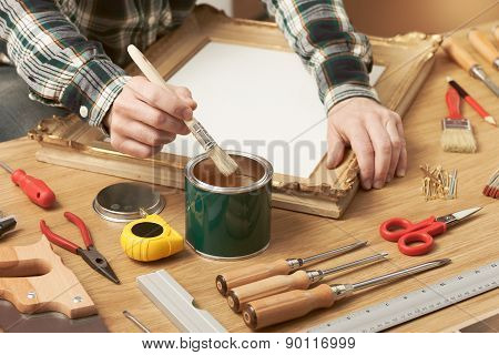 Decorator Varnishing A Wooden Frame