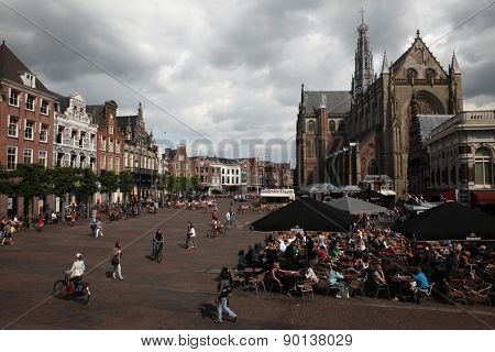 HAARLEM, NETHERLANDS - AUGUST 9, 2012: People walk in front of the Grote Kerk (Great Church) on the Grote Markt in Haarlem, North Holland, Netherlands.