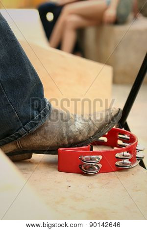 Musician Are Using A Foot Knocked Tambourine