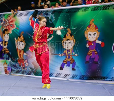 JAKARTA, INDONESIA - NOVEMBER 15, 2015: Liudmyla Temna of Ukraine performs the movements in the women's Shuangjian event at the 13th World Wushu Championship 2015 held in Istora Senayan, Jakarta.