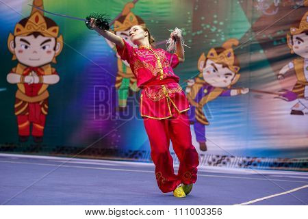 JAKARTA, INDONESIA - NOVEMBER 15, 2015: Liudmyla Temna of Ukraine performs the movements in the women's Shuangjian event at the 13th World Wushu Championship 2015 held in Istora Senayan, Jakarta.