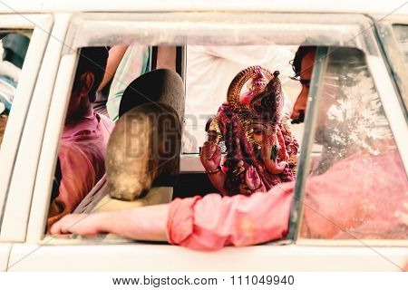 Man in the car carriying God Idol.