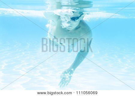 young man swimming the front crawl style in a pool
