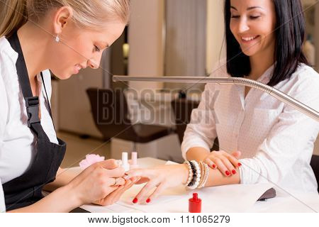 Happy women doing manicure