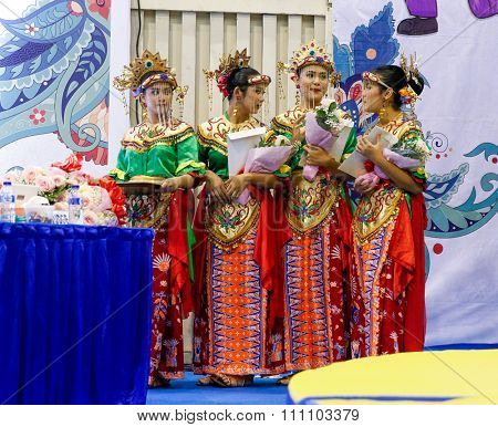 JAKARTA, INDONESIA - NOVEMBER 16, 2015: Ladies dressed in traditional Indonesian costumes prepare for the medals award ceremony at the 13th World Wushu Championship 2015 held in Istora Senayan Stadium