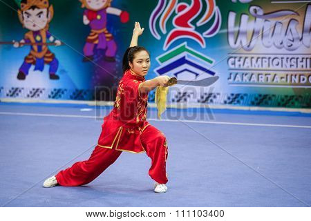 JAKARTA, INDONESIA - NOVEMBER 16, 2015: Ami Li of the USA performs the movements in the women's Daoshu event at the 13th World Wushu Championship 2015 at the Istora Senayan Stadium.