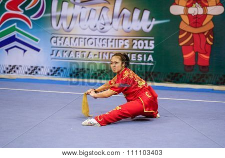 JAKARTA, INDONESIA - NOVEMBER 16, 2015: Ami Li of the USA performs the movements in the women's Daoshu event at the 13th World Wushu Championship 2015 at the Istora Senayan Stadium.