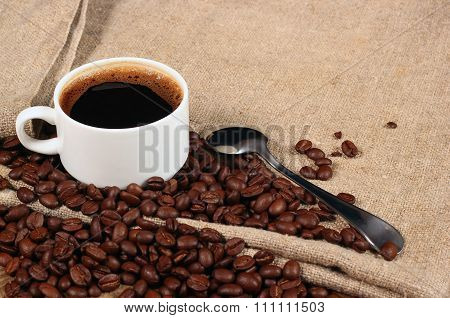 Coffee Beans And Teaspoon With A Cup Of Fragrant Drink