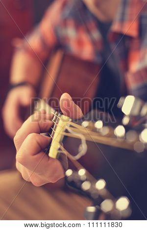 Guitarist Playing On Acoustic Guitar