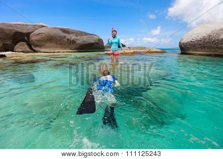 Split photo of mother and son family snorkeling in turquoise ocean water at tropical island of Virgin Gorda, British Virgin Islands, Caribbean