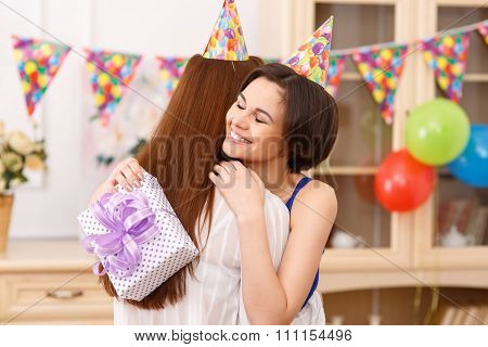 Birthday girl hugging her friend.