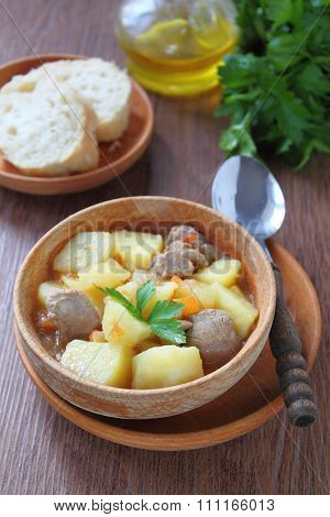 potato roast meat on wooden plate and wooden saucer