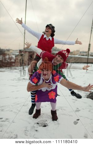 ST. PETERSBURG, RUSSIA - NOVEMBER 25, 2015: A. Yagudin (Karlsson), M. Petrova (Lillebror), and A. Tikhonov (Froken Bock) in characters of Karlsson-on-the-roof on the roof of the film studio Lenfilm
