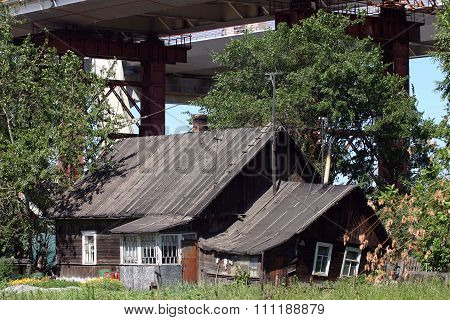 Construction Bridge Over House Which Is Home To Farming Family.
