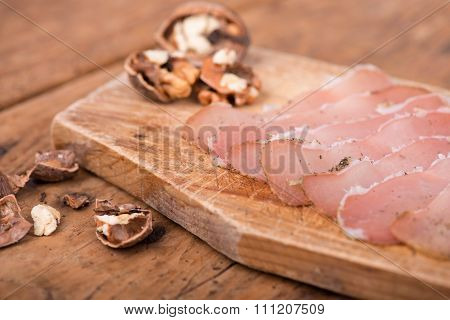 dried pork tenderloin on a rough wooden rustic table