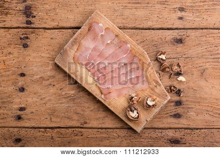dried pork tenderloin on a rough wooden rustic table