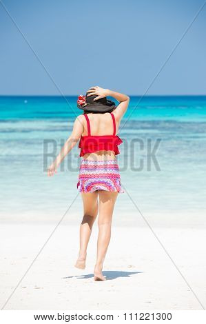The girl on koh ta chai beach running down into the sea