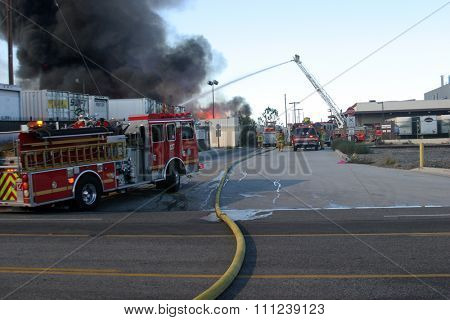 HARBOR GATEWAY, CALIFORNIA- DECEMBER 12, 2015: Fire erupts at recycling yard in Harbor Gateway. Dozens of Fire Trucks arrive to help extinguish an industrial fire, California Dec. 12, 2015 
