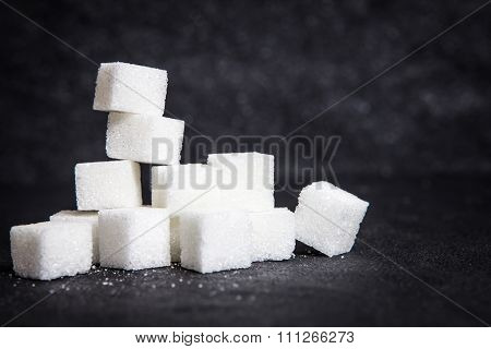 Cloose Up White Sugar Cubes On Black Stone Plate Background