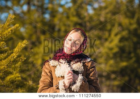 Portrait of the beautiful young woman in National suit in a park