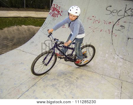 Child With Bike In The Half Pipe