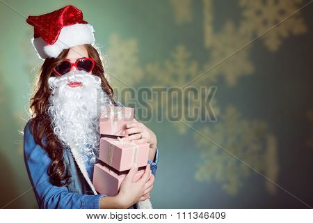 Funny girl wearing xmas santa hat and beard holding presents