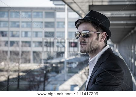 Man Wearing Hat and Looking Out Window