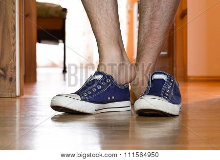 Man Is Puting On  Sneakers