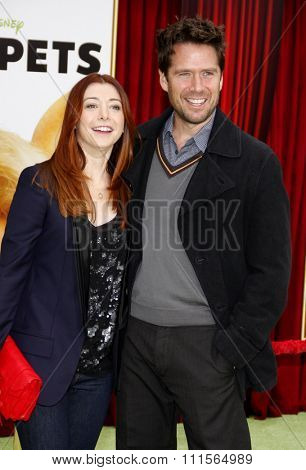 HOLLYWOOD, CA - NOVEMBER 12, 2011. Alyson Hannigan and Alexis Denisof at the World premiere of 'The Muppets' held at El Capitan Theater in Hollywood, USA on November 12, 2011.