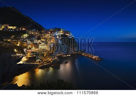 Manarola Night. Village, Rocks And Sea. Cinque Terre, Italy