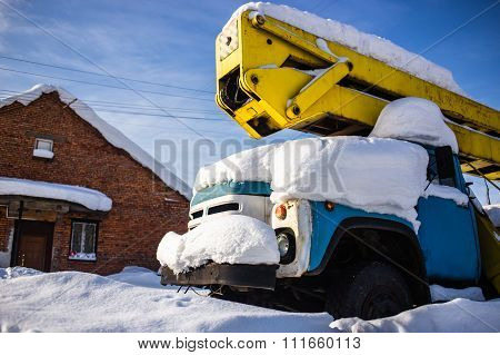 Car covered in several inches of snow