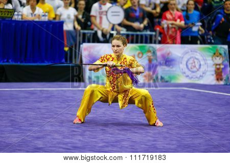 JAKARTA, INDONESIA - NOVEMBER 17, 2015:Liudmyla Temna of Ukraine performs the movements in the women's Jianshu event at the 13th World Wushu Championship 2015 in Istora Senayan Stadium.