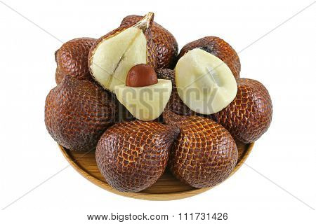 A wooden bowl full of Tropical fruit named Salak (Salacca zalacca) isolated on white background