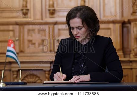 ST. PETERSBURG, RUSSIA - DECEMBER 15, 2015: Minister of culture of the Republic of Abkhazia Elvira Arsalia signs the plan of cooperation with the Russian Ministry of culture during Cultural Forum