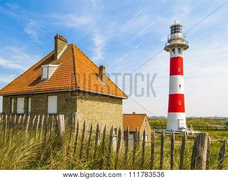 Lighthouse in sandy dunes of the North Sea