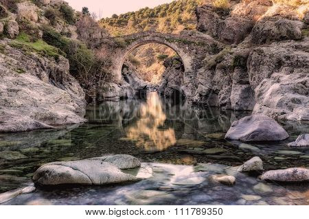 River Passing Through Genoese Bridge At Asco In Corsica