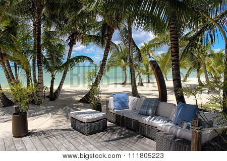 Rattan chairs on a wooden deck near the beach