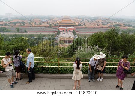 BEIJING - CIRCA JUNE , 2015: Tourists on a viewing platform in the Jingshan park. Observation desk Jingshan Park is the highest point of the old Beijing, it offers view of the Imperial Forbidden City