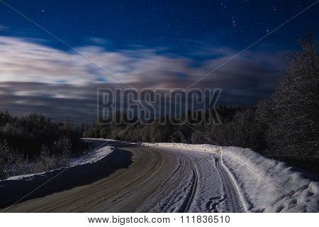 Winter night landscape with the stars and the road