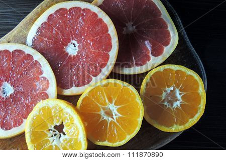 Grapefruit And Mandarin On A Wooden Board