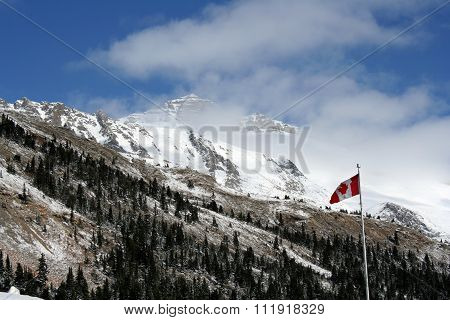 Canadian Rocky mountains with flag