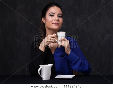 Attractive Brunette Keeping A Cup