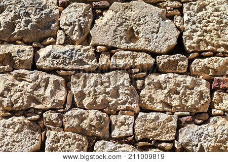 Wall made of stones of different shapes and sizes. Background