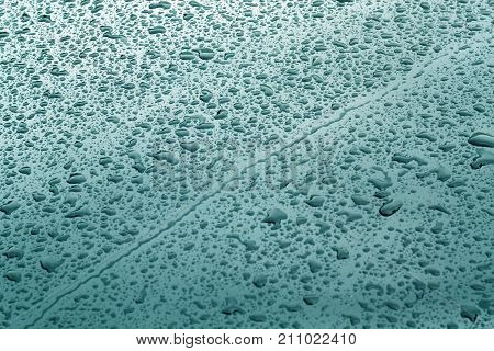 Rain Drops On Cyan Color Metal Car Surface.