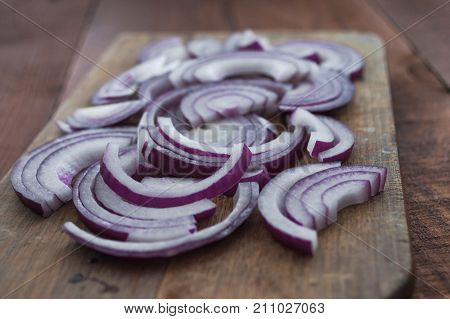 Food Preparation, Cooking Concept: Sliced Fresh Red Onions On Rustic Wooden Background