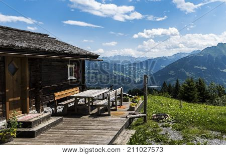 Matschwitz Austria - July 21 2017: Old wooden cabin in Matschwitz with in the background the mountains of Montafon on a summers day Austria