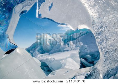 Endless blue ice hummocks in winter on the frozen Lake Baikal. Russia